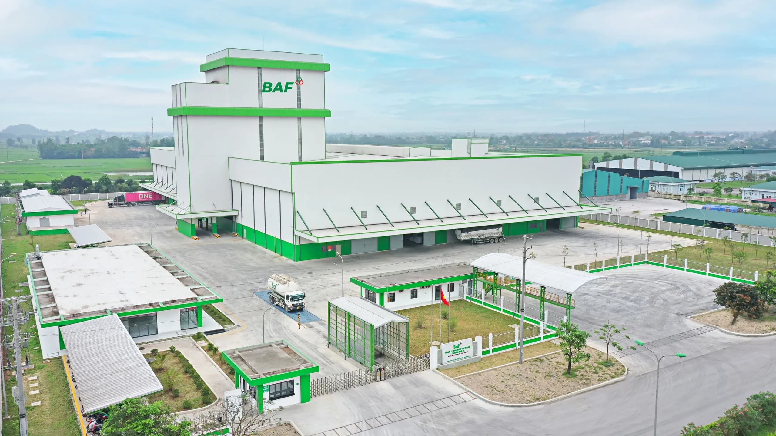 Aerial view of the large ILAF industrial complex with green and white buildings.